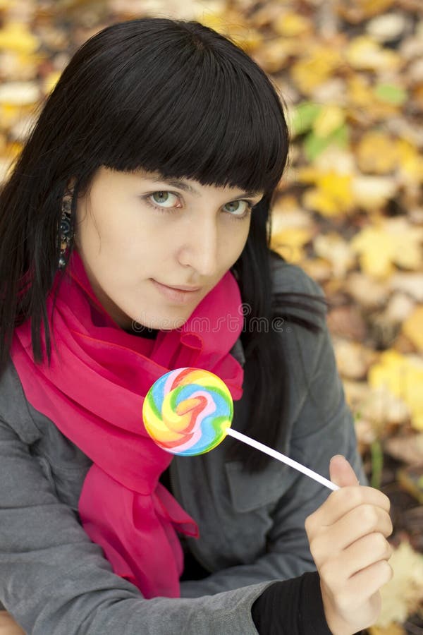 Woman eating candy lollipops