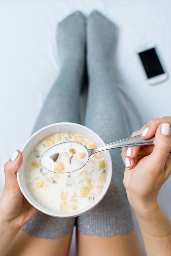 Attractive Woman Eating Cereals Sitting On Bed Stock Image Image of