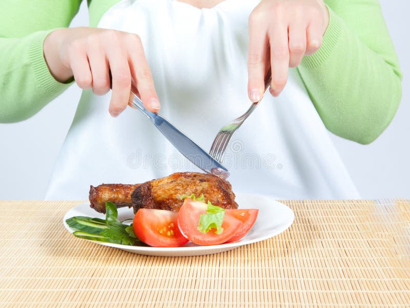 Woman eating chicken