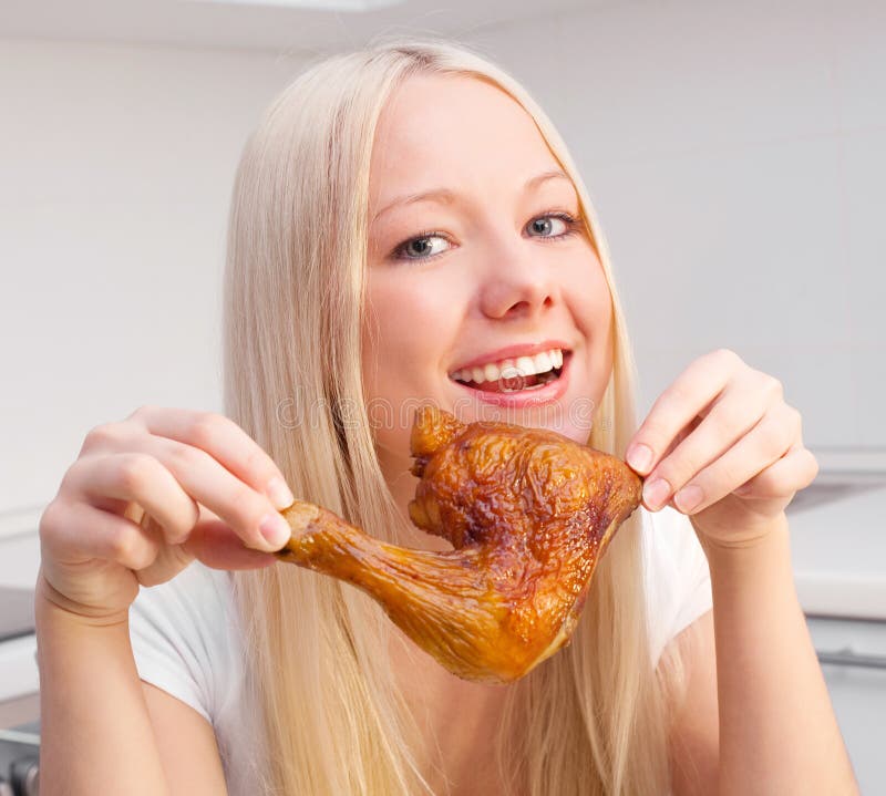 Woman eating chicken