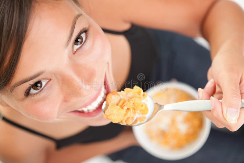 Woman eating cornflakes cereals