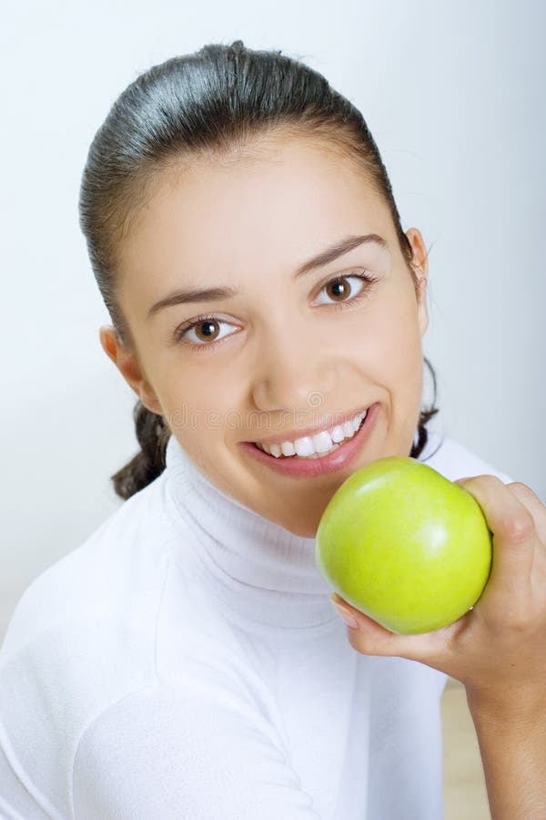 Woman eating fresh green apple