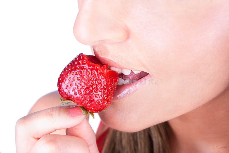 Woman are eating fresh strawberry