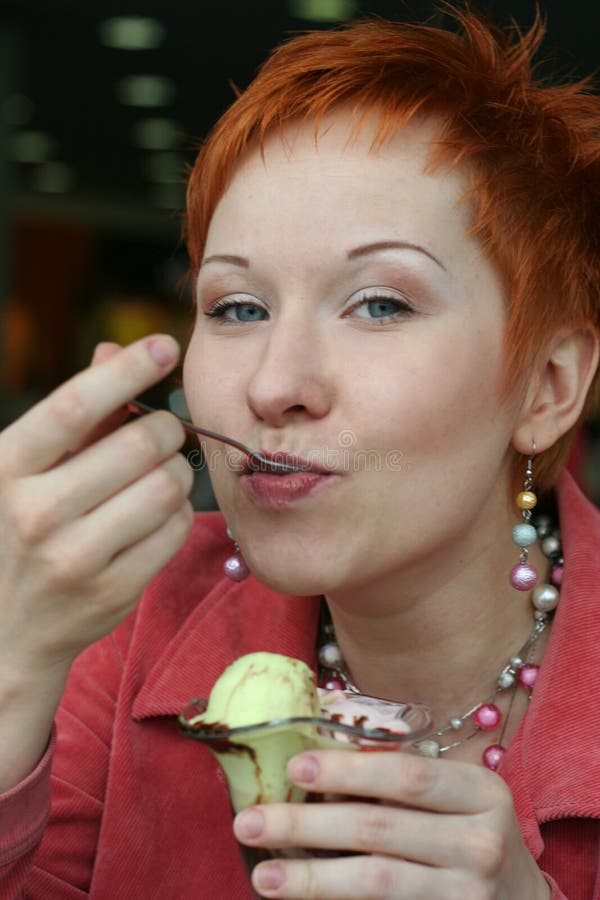 Woman eating ice cream royalty free stock photos