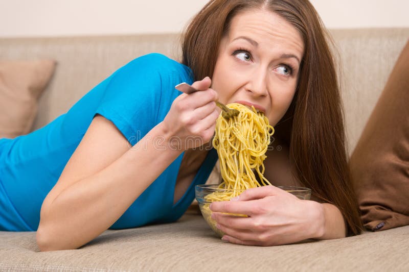 Woman eating noodles.