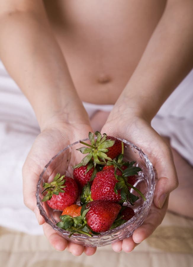 Woman eating strawberry