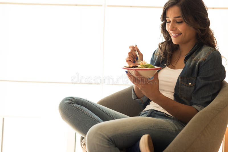 Woman eating a vegan bowl. Of superfoods stock photo