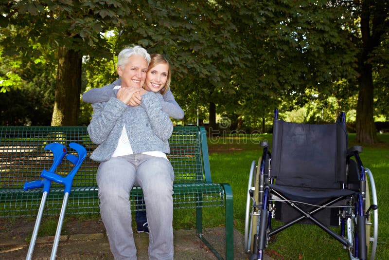 Woman embracing elderly woman oin royalty free stock photography