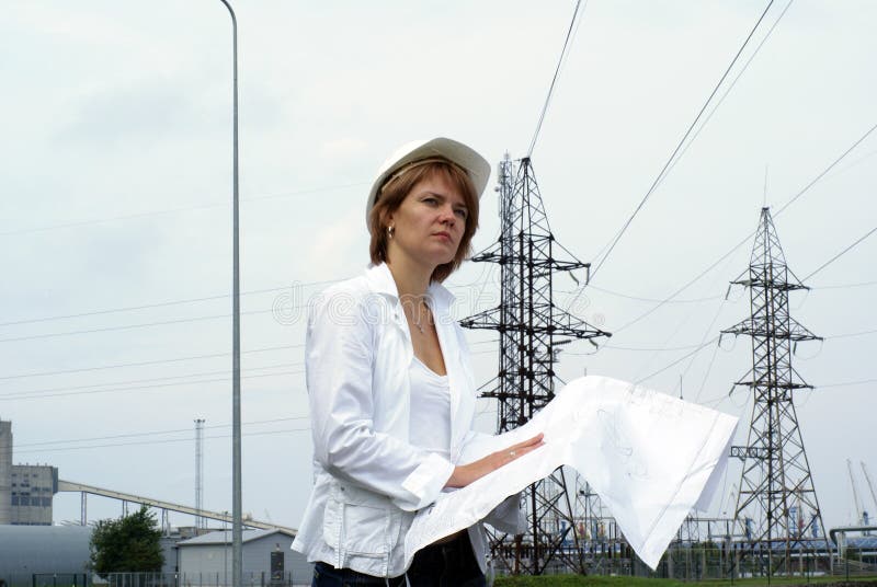 Woman engineer or architect safety hat drawings