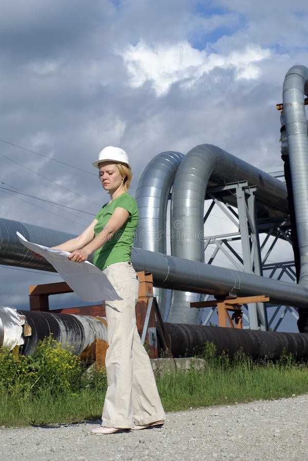 Woman engineer with safety hat, drawings