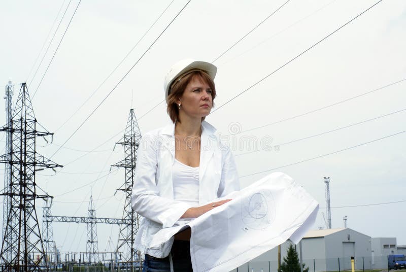 Woman engineer with white safety hat drawings