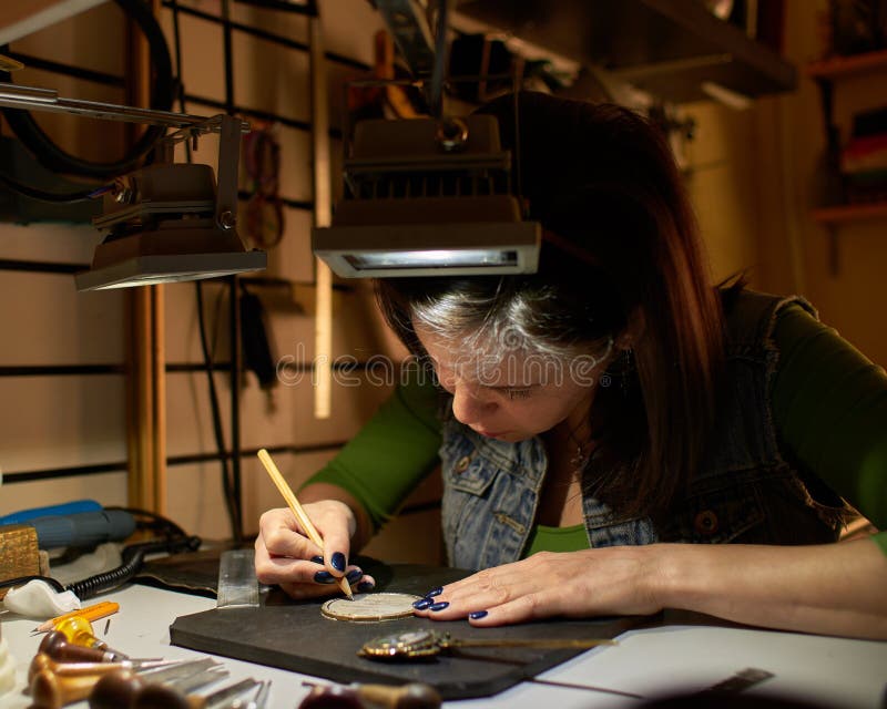 Woman engraver at work. stock photo. Image of female - 150890982
