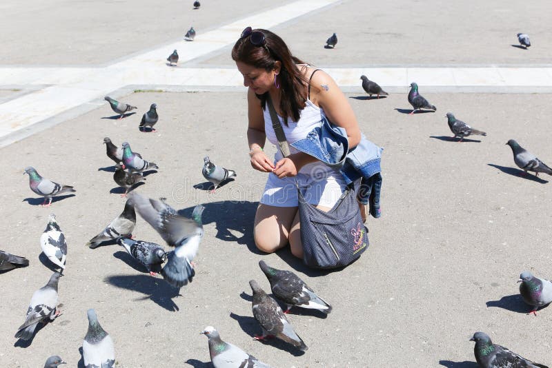 Woman enjoy with Pigeon in athene