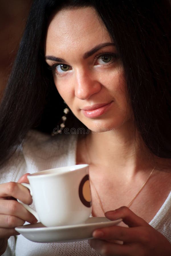 Woman enjoying latte coffee in caf