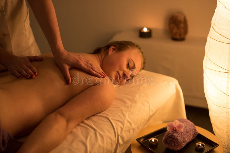Woman enjoying relaxing back massage in cosmetic spa centre in s royalty free stock image Woman enjoying relaxing back massage in cosmetic spa centre in s royalty free stock image