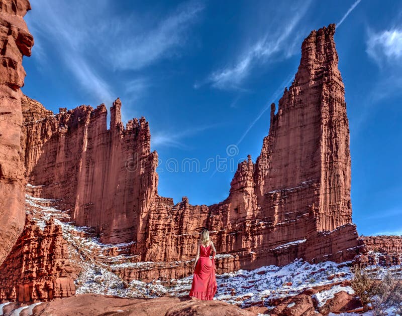 Woman enjoying scenic view of sandstone formations.