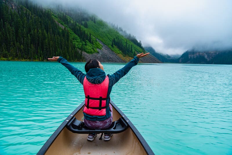 Woman enjoying the view of Lake Louise from Canoe