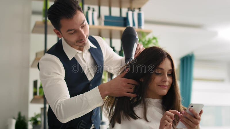 Woman enjoying wireless internet in hair salon