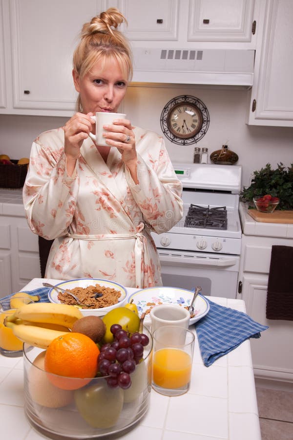 Woman Enjoys Coffee In Kitchen