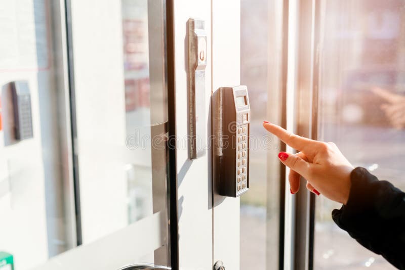 Woman entering pin code to security system royalty free stock photography