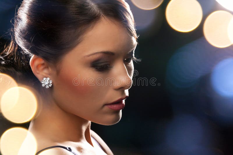 Woman in evening dress wearing diamond earrings