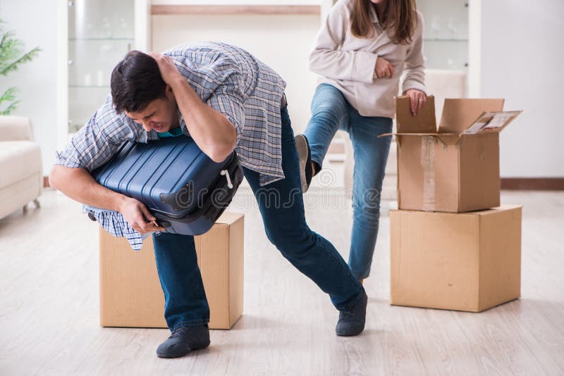 The woman evicting man from house during family conflict stock photo The woman evicting man from house during family conflict stock photo