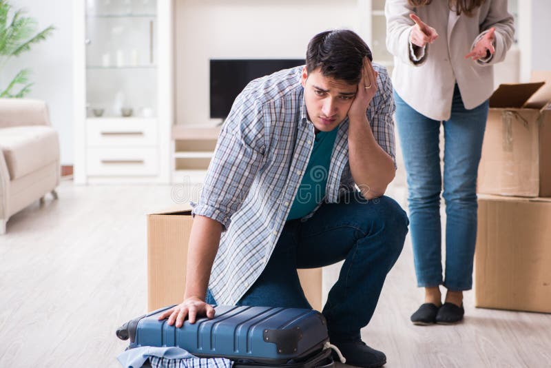 The woman evicting man from house during family conflict stock images The woman evicting man from house during family conflict stock images