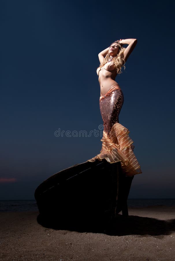 Woman in exotic dress standing on a boat