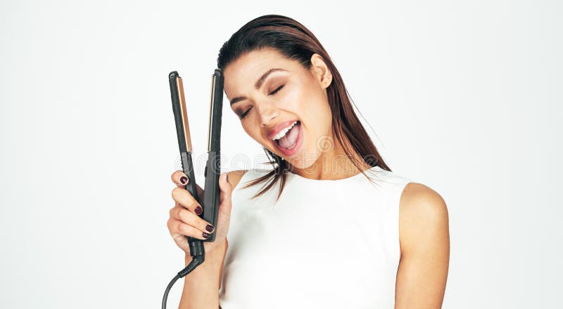 Woman holding a hair straightener