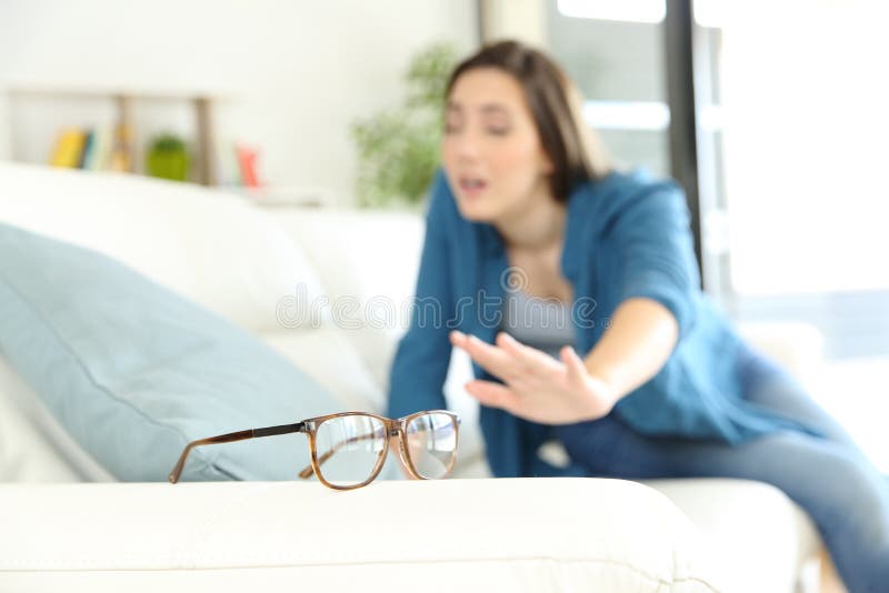 Woman with eyesight problem searching eyeglasses