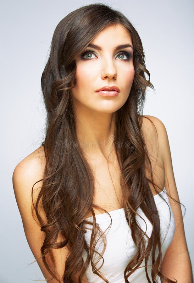 Woman face close up beauty portrait. Girl with long hair lookin