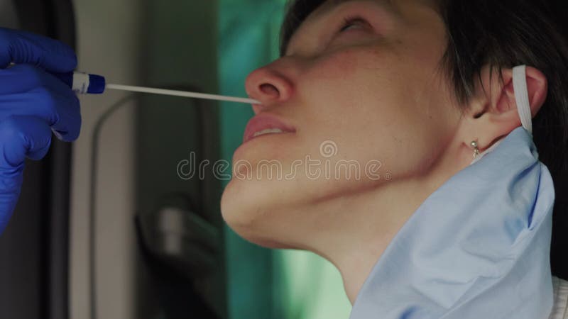 Woman having car nasal smear PCR test for possible infection