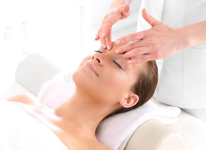 Woman at face massage stock photography