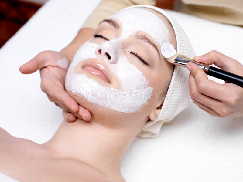 Woman with facial mask at beauty salon