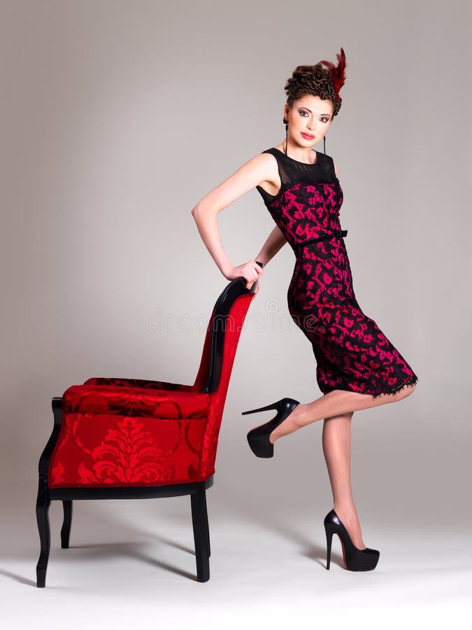 Woman with fashion hairstyle and red armchair