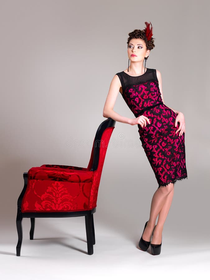 Woman with fashion hairstyle and red armchair