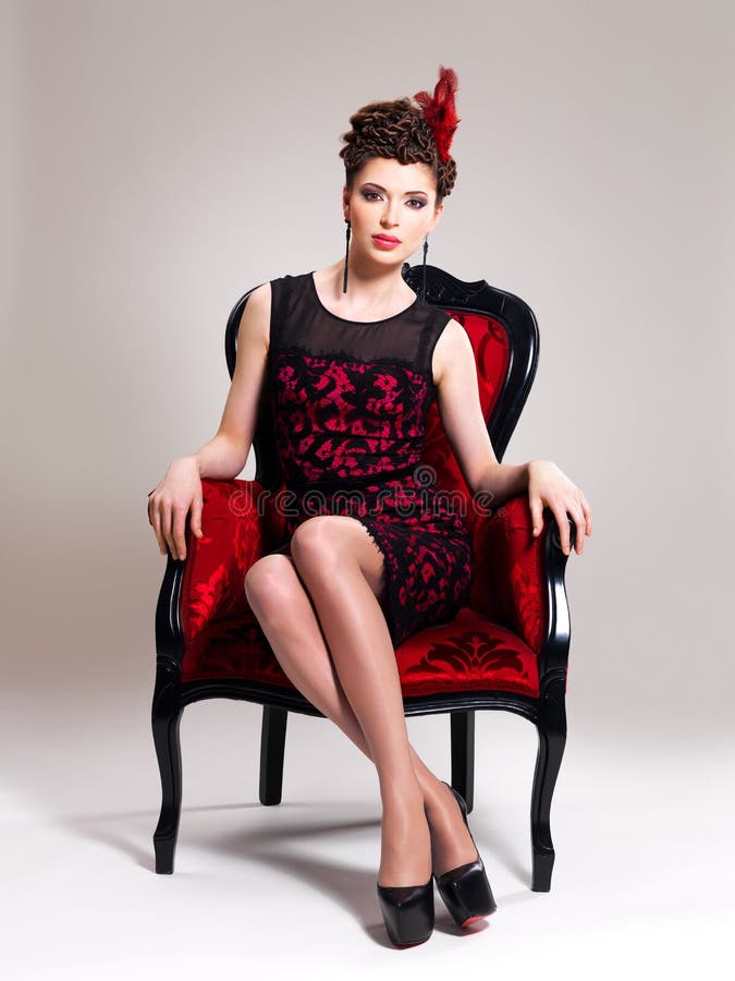 Woman with fashion hairstyle and red armchair