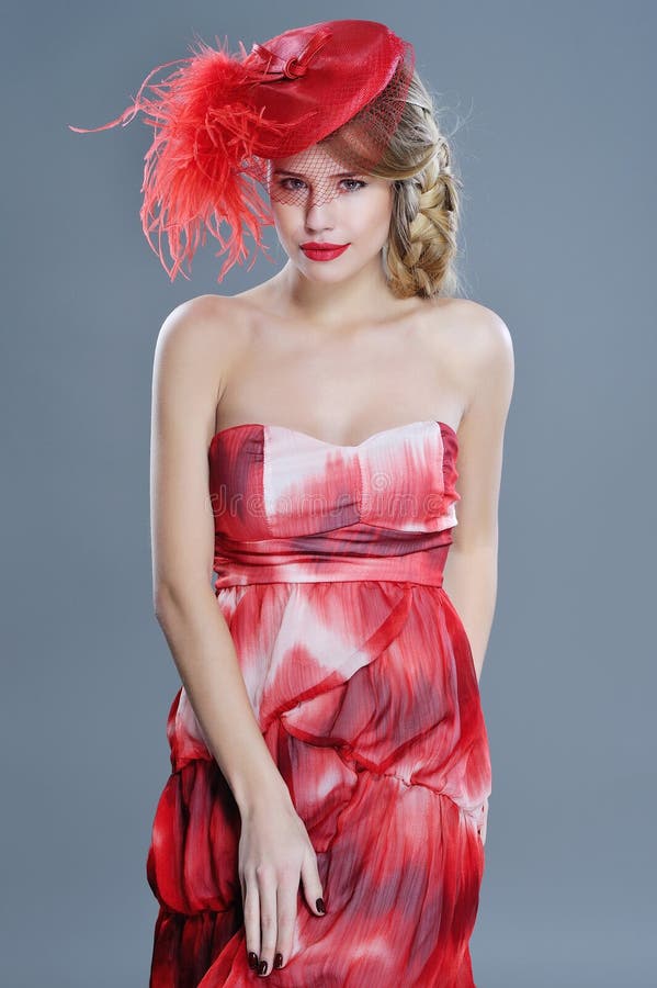Woman fashion portrait in red vintage hat with feathers