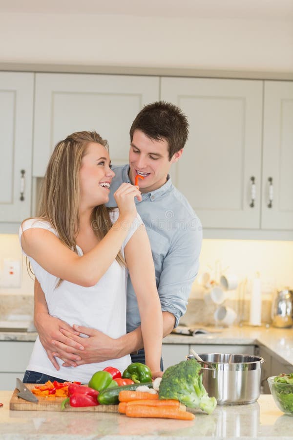 Woman feeding man jokingly