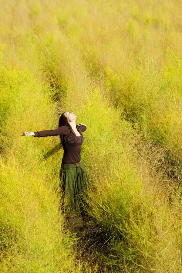 Woman feeling freedom in a field.