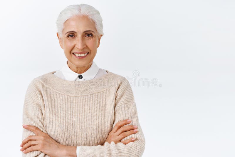 Woman feeling reliance and confidence in future. Self-assured happy and pleased senior woman with grey combed haircut