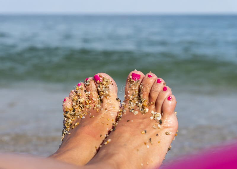 Woman Feet Closeup on a Beach. Pink Nails on Toes Stock Photo - Image ...