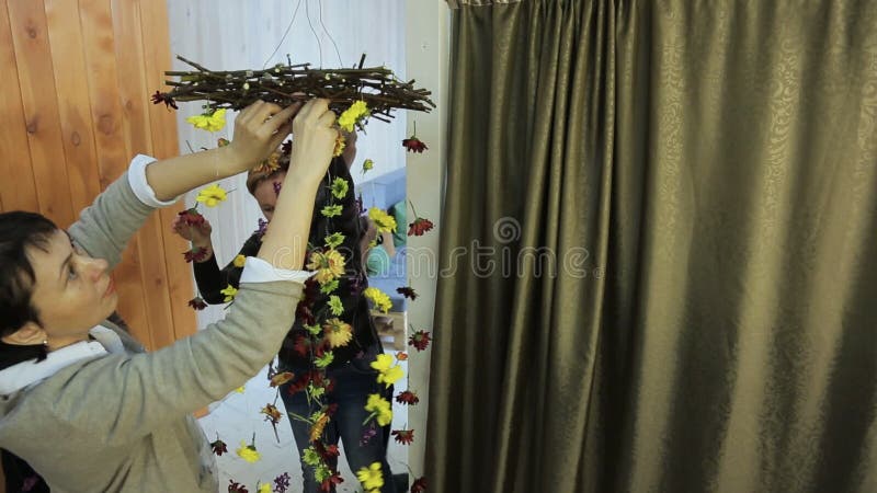 Woman is finishing making floral decoration.