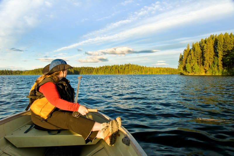 Woman fishing by boat stock image. Image of trees ...