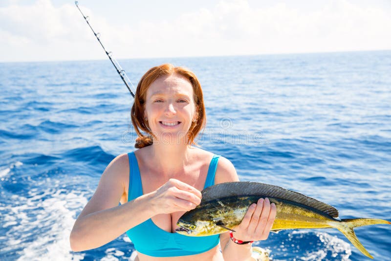 Woman fishing Dorado Mahi-mahi fish happy with trolling catch on boat deck. Woman fishing Dorado Mahi-mahi fish happy with trolling catch on boat deck