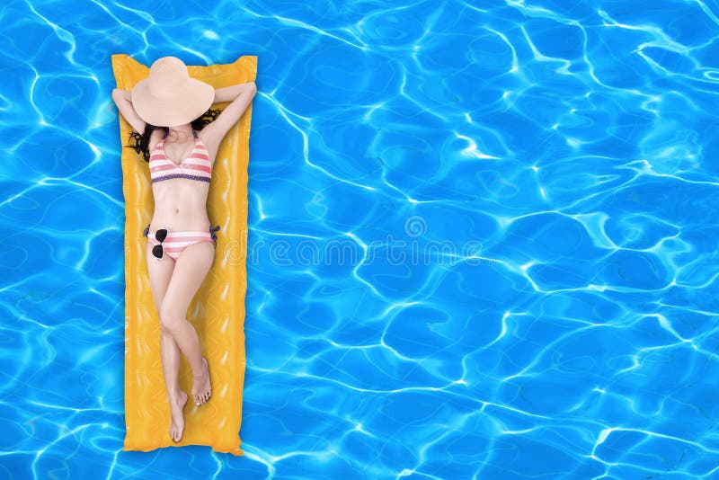 Woman floating on a pool mattress 1