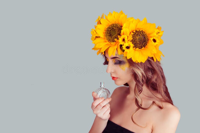 Woman with floral headband holding perfume bottle smelling aroma royalty free stock photos Woman with floral headband holding perfume bottle smelling aroma royalty free stock photos