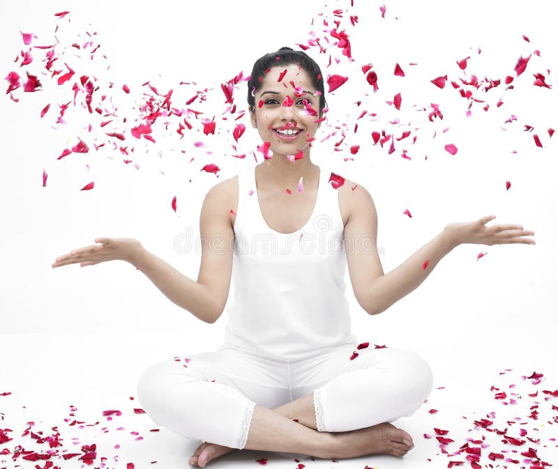 Woman with flying rose petals