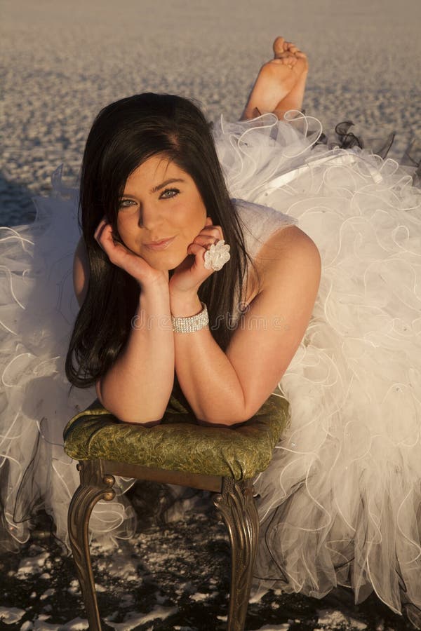 Woman formal dress ice barefoot slight smile