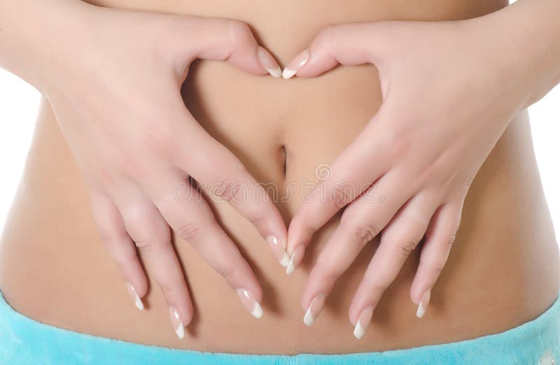 Woman forming heart shape on belly